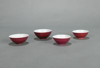 <b>FOUR RED-GLAZED PORCELAIN BOWLS</b>