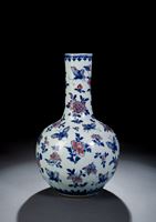 <b>A BLUE AND WHITE AND COPPER-RED DECORATED BUTTERFLY AND FLOWER BOTTLE VASE</b>