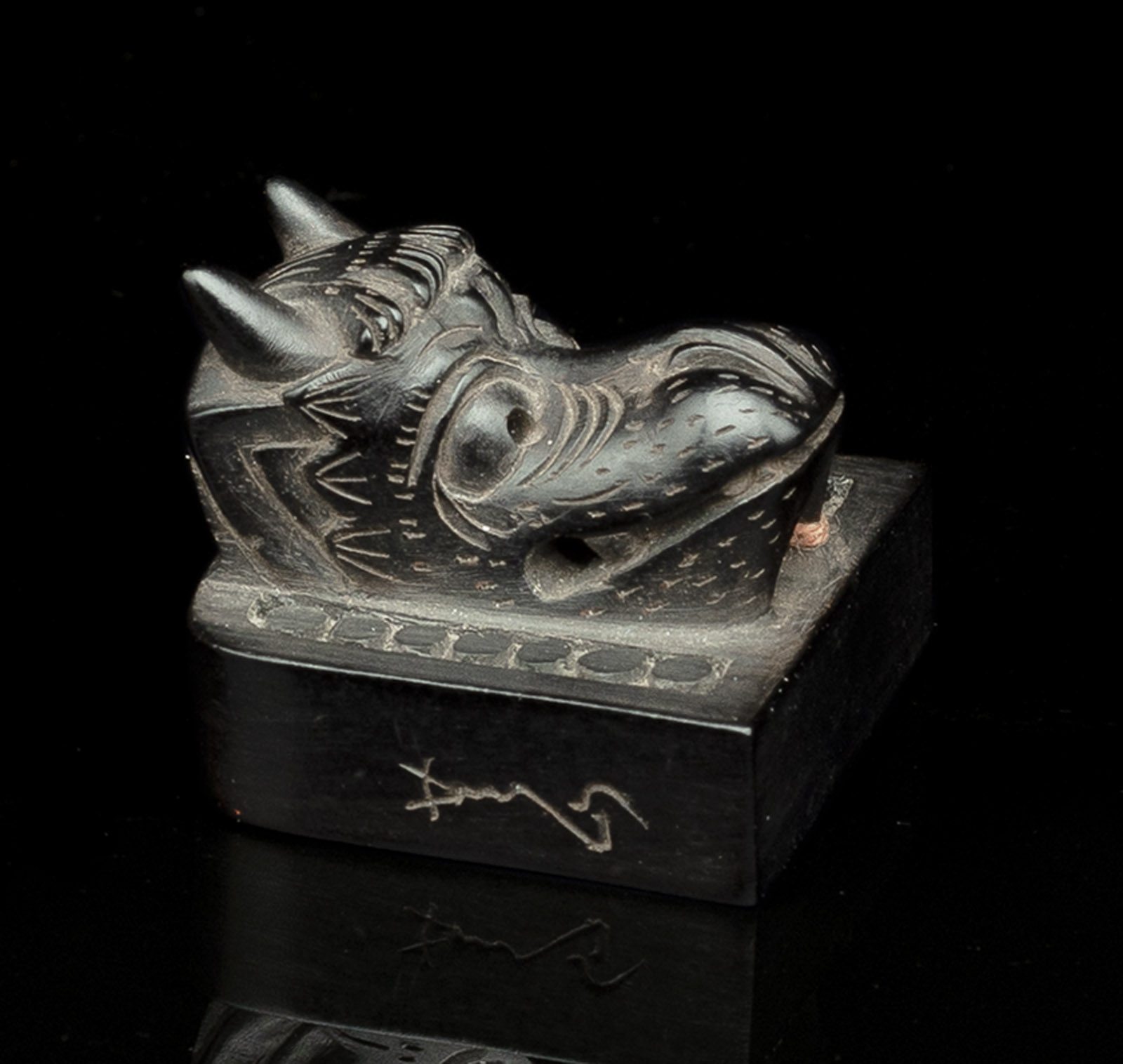 <b>A WOOD NETSUKE OF AN INK STONE WITH A DRAGON HEAD</b>