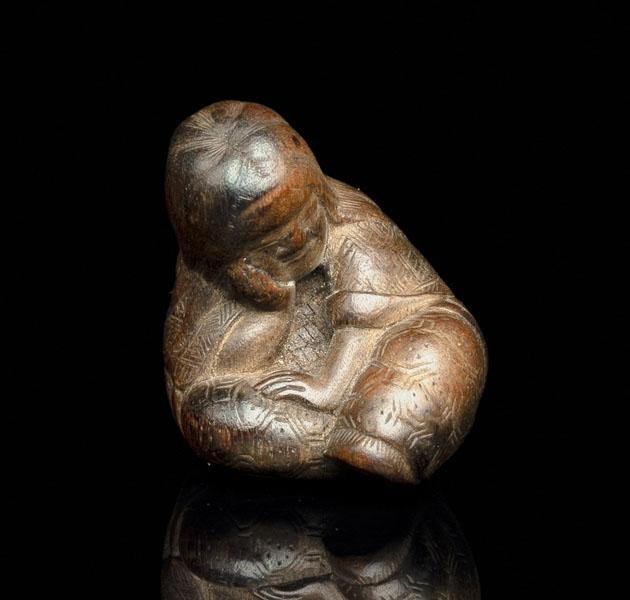 <b>A CARVED WOOD NETSUKE OF SLEEPING SHOJO</b>