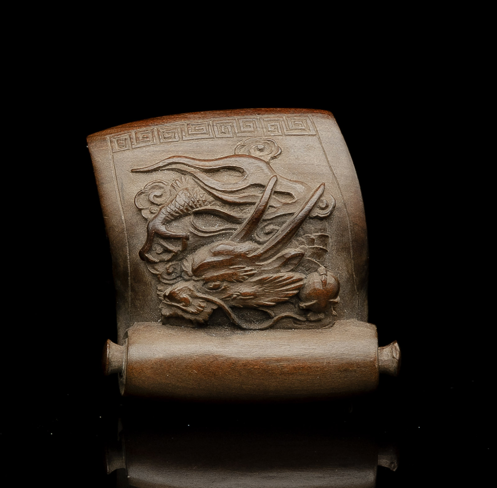 <b>A CARVED WOOD NETTSUKE OF A HANDSCROLL DEPICTING A DRAGON</b>