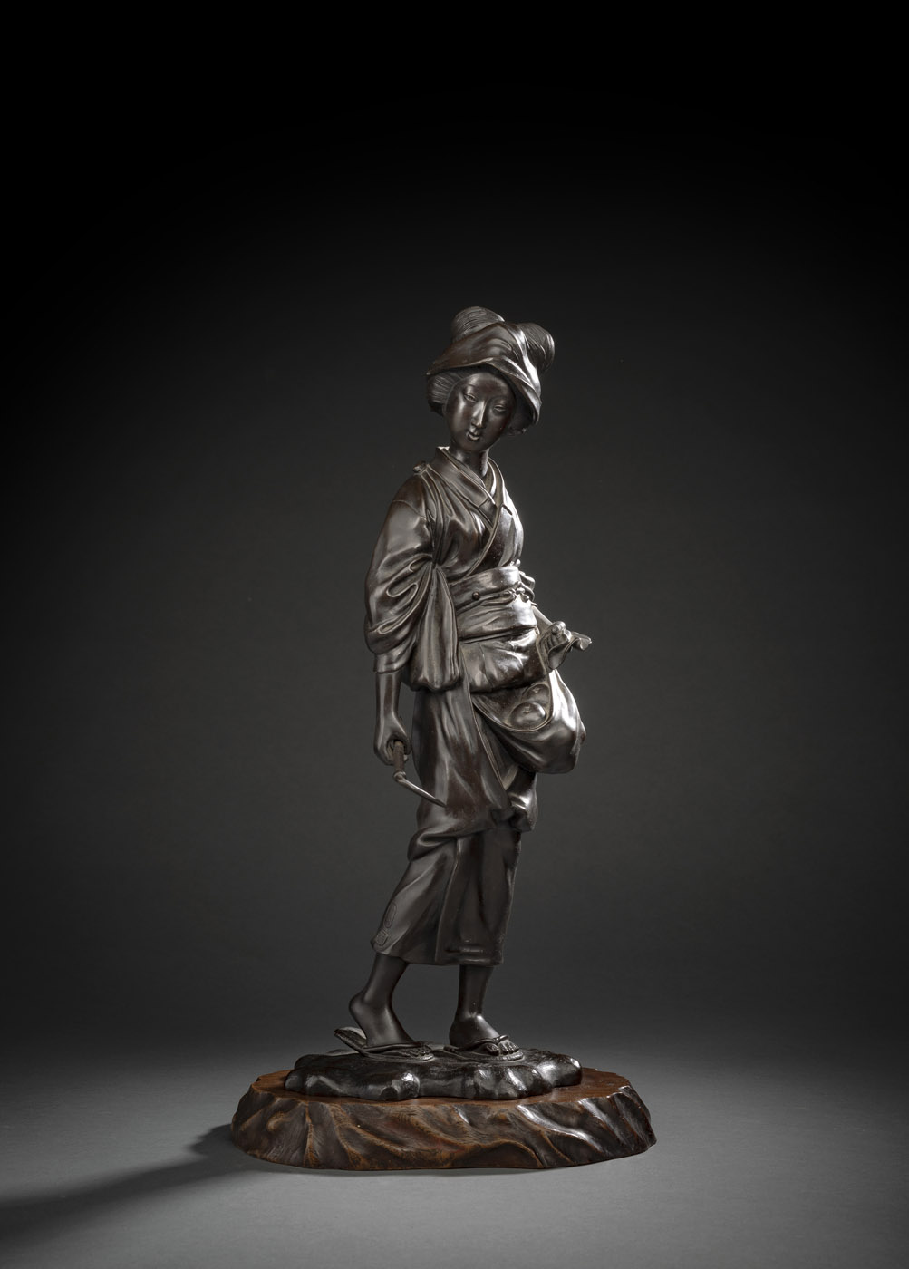 <b>A BRONZE FIGURE OF A PHEASANT WOMAN HOLDING A SICKLE AND A BUNDLE OF FRUITS</b>