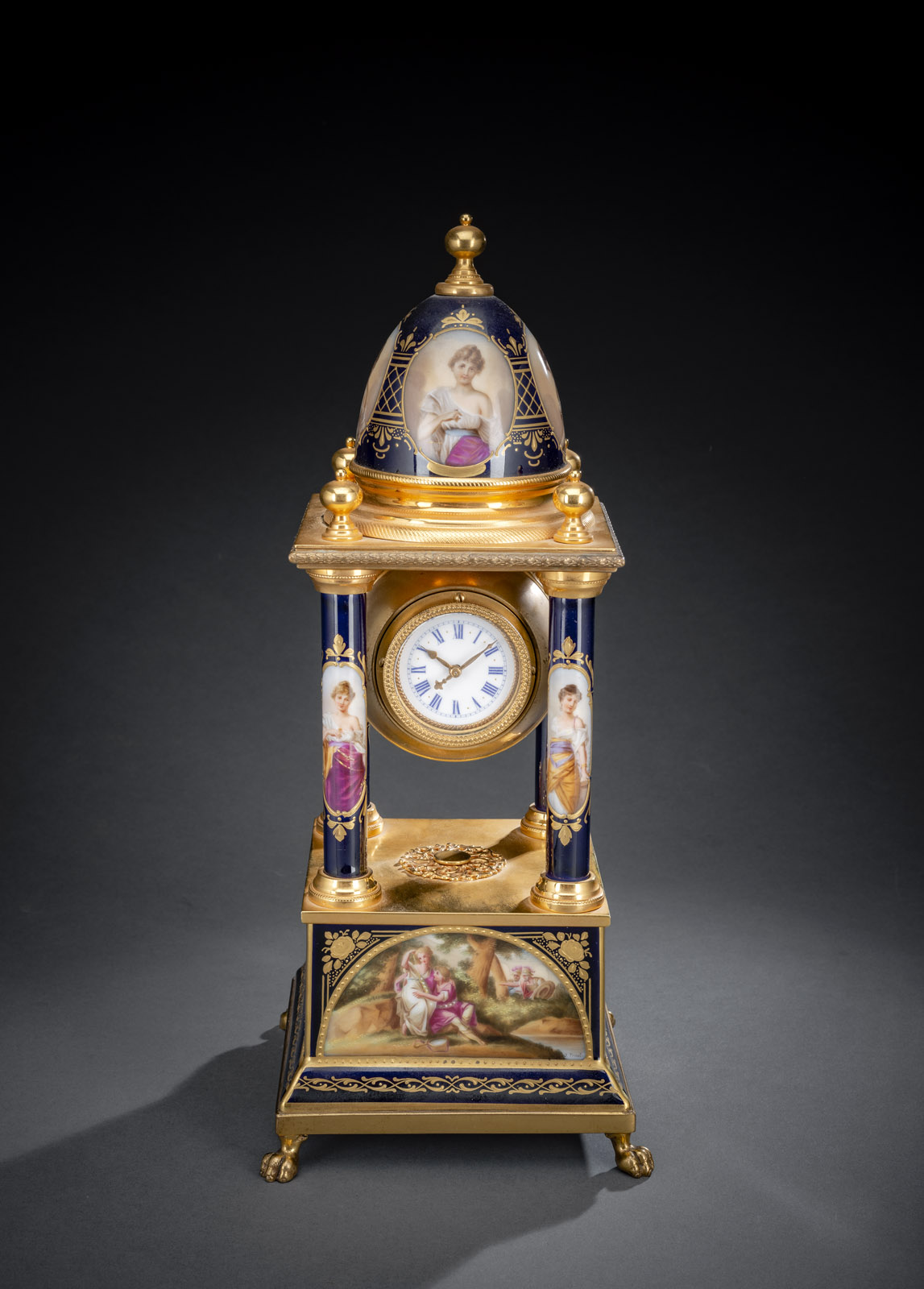 <b>A BRASS MOUNTED BLUE FOND, GILT AND PAINTED PORCELAIN TABLE CLOCK</b>