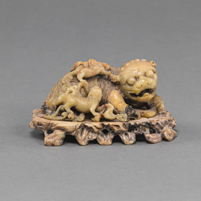 <b>A SOAPSTONE CARVING OF A FO LION</b>