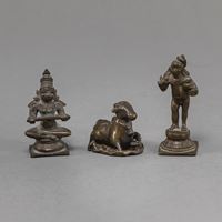 <b>THREE BRONZE FIGURINES OF A SEATED DIVINITY, NANDI AND KRISHNA</b>