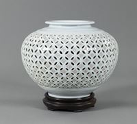 <b>A CELADON-GLAZED PORCELAIN VASE WITH PIERCED SHIPPO PATTERN AND FLOWERHEADS</b>