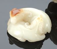 <b>A LIGHT-GREEN AND CARAMEL JADE GROUP OF TWO RAMS</b>