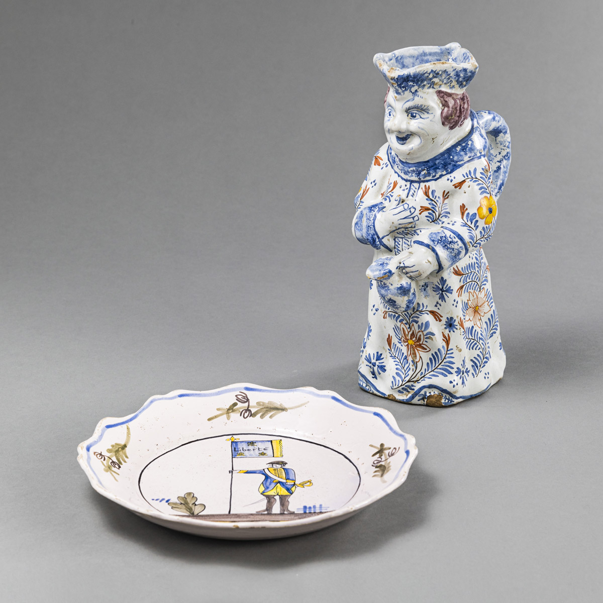 <b>A MONK SHAPED FAYENCE JAR AND A DISH WITH SOLDIER</b>