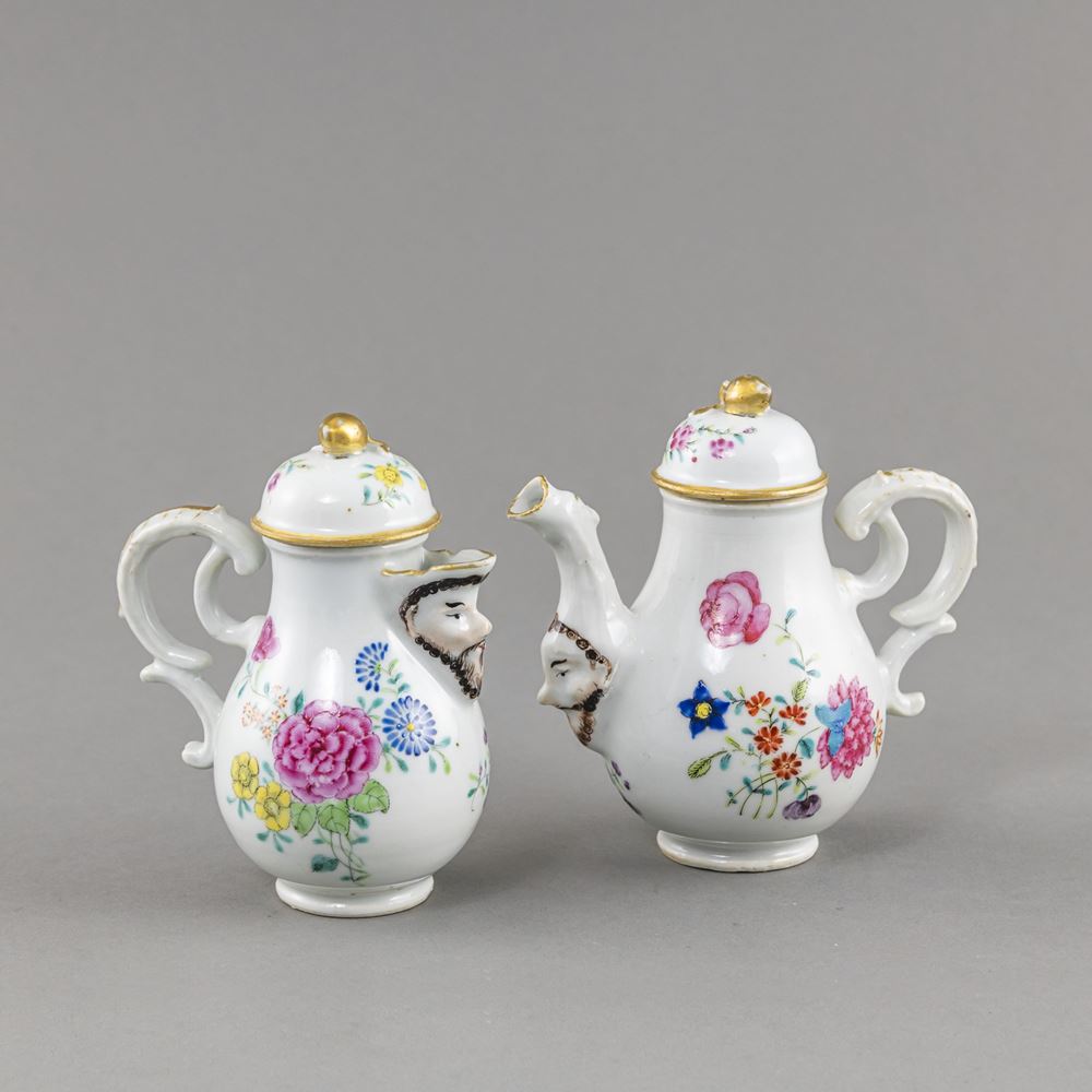 <b>A SMALL 'FAMILLE ROSE' EXPORT PORCELAIN TEAPOT AND A MILK JUG WITH FLORAL DECORATION AND MASCARON AT THE SPOUT</b>