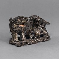 <b>A PARTIALLY SILVERED COPPER ON WOOD CARVING OF A FO LION WITH YOUNG</b>