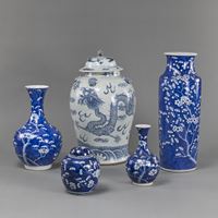 <b>FOUR BLUE AND WHITE PRUNUS PORCELAIN VASES AND A DRAGON VASE WITH COVER</b>