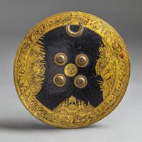 <b>A ROUND GOLD- AND LACQUER-DECORATED SHIELD WITH COURT SCENES, TIGERS, ELEPHANTS, IN THE INDO-PERSIAN STYLE</b>