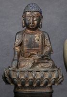 <b>A GILT-LACQUERED BRONZE FIGURE OF A SEATED BUDDHA ON A SEPARATE LOTOS</b>