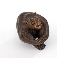 <b>A CARVED-WOOD NESTUKE OF A SEATED MONKEY</b>