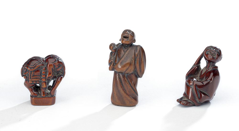 <b>A GROUP OF FOUR WOOD NETSUKE</b>