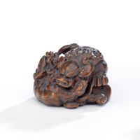 <b>A FINE BOXWOOD NETSUKE OF A GROUP OF THREE PLAYFUL SHISHI</b>