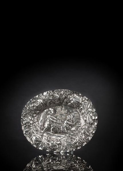Chased silver showing two boys with fish and birds in a landscape. Town mark, maker's mark of Christian I Hornung (Seling, Nr. 1576). Ca. 157 grams. Minor dents to rim.