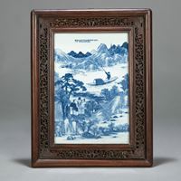 <b>A FINELY PAINTED UNDERGLAZE BLUE PORCELAIN TILE DEPICTING A LANDSCAPE WITH TWO SCHOLARS CONVERSING ON ROCKS AND A BOAT IN A CARVED WOODEN FRAME</b>