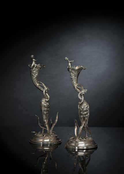<b>TWO FIGURAL SILVER CANDLESTICKS WITH CRANE AND PUTTI</b>