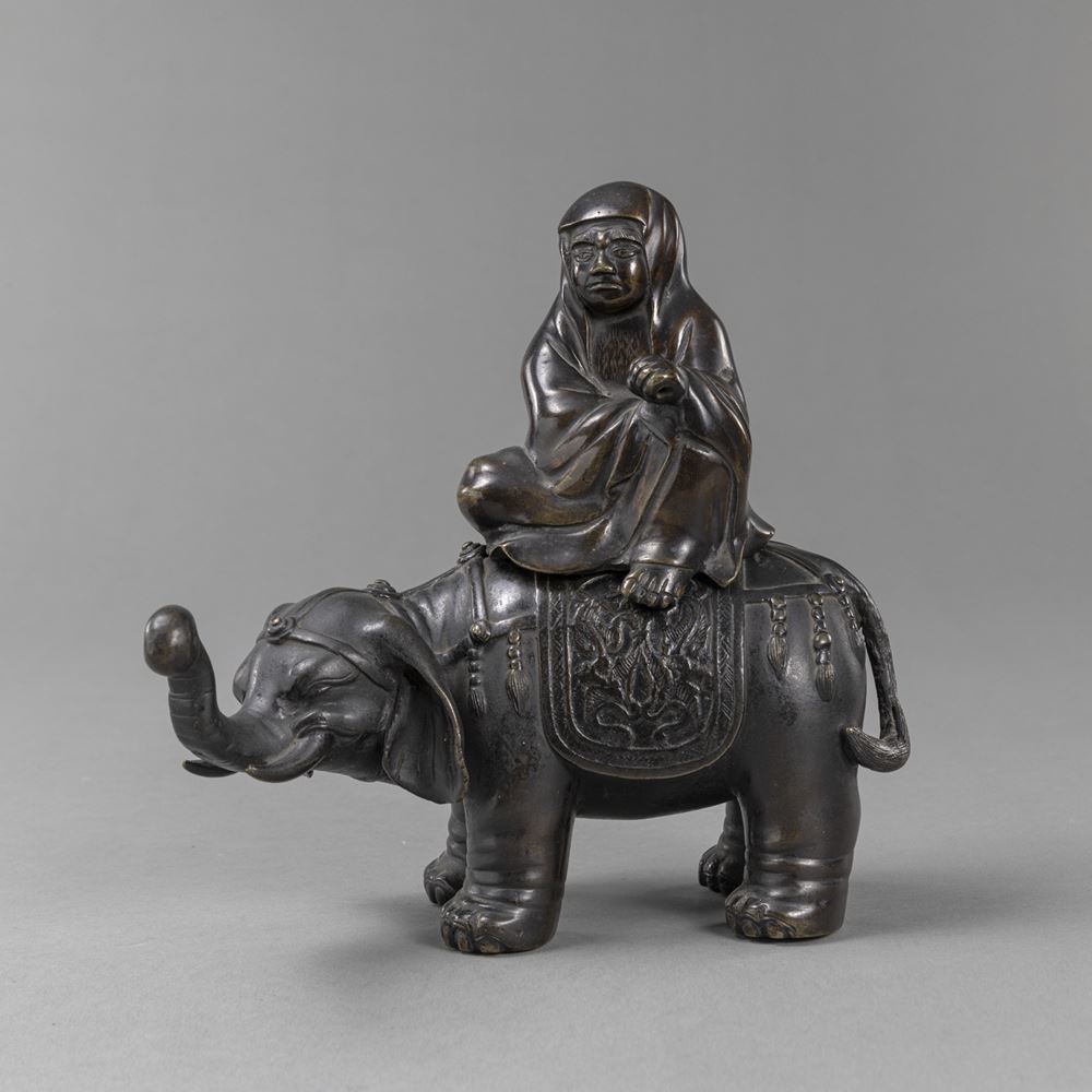 <b>A BRONZE FIGURE OF DARUMA RIDING AN ELEPHANT</b>