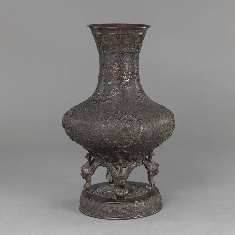 <b>A FOUR-FOOTED BRONZE VASE WITH STYLIZED CLOUDS IN RELIEF</b>