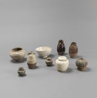 <b>A CREME-GLAZED BOWL, A LIDDED JARLET, AND SEVEN VARIOUS CERAMIC VESSELS</b>