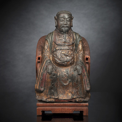 <b>A GILT-LACQUERED BRONZE MODEL OF GUANDI SEATED ON A CARVED WOODEN THRONE</b>