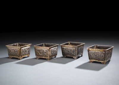 <b>A SET OF FOUR SILVER SQUARE JARDINIÉRES WITH DRAGON, BAMBOO, ORCHIDS AND PRUNUS RELIEF</b>
