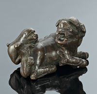 <b>A BRONZE PAPER WEIGHT IN SHAPE OF A RECUMBENT LION AND IT'S YOUTH</b>