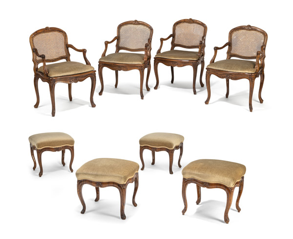 <b>A SET OF FOUR SOUTHGERMAN BAROQUE CARVED WALNUT FAUTEUILS AND A SET OF FOUR STOOLS</b>