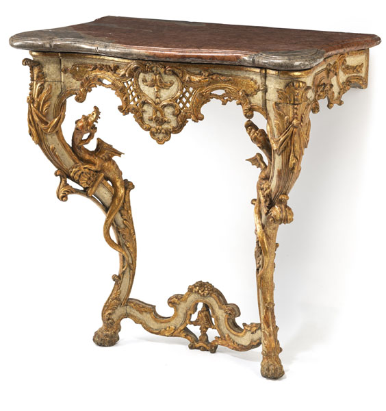 Richly carved with acanthus foliage, flowers and two winged dragons climbing up the legs, parcially openwork decor and with red and gray fleckted and moulded marble top (broken and restored). Restorations, minor damages due to age.