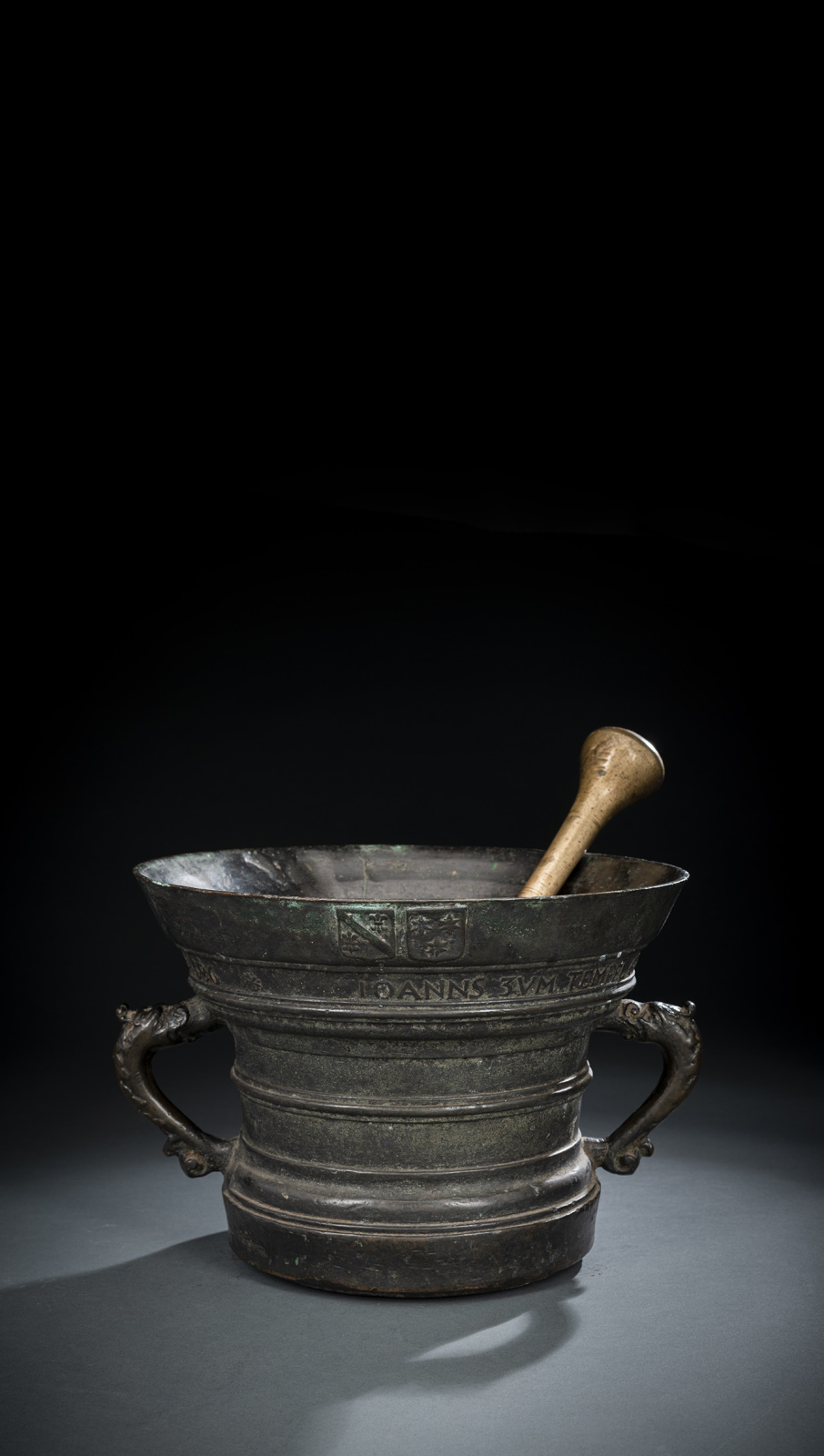 With two fish handles. Inscribed underneath the rim 