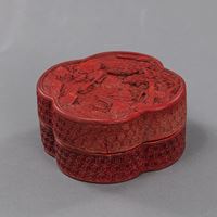 <b>A SMALL CARVED CINNABAR LACQUER QUATREFOIL BOX AND COVER DEPICTING A SCHOLAR ON A BOAT PLAYING THE QIN (ZITHER)</b>