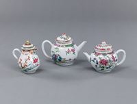 <b>TWO SMALL PORCELAIN TEAPOTS AND A MILK JUG, DECORATED WITH 'FAMILLE ROSE' PAINTING</b>