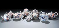 <b>A GROUP OF SEVEN IMARI TEAPOTS AND COVERS AND  A TEA CADDY</b>