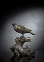<b>A WELL-CAST TWO-PART BRONZE MODEL OF A BIRD OF PREY SEATED ON A TREE WITH PUPILS INLAID</b>