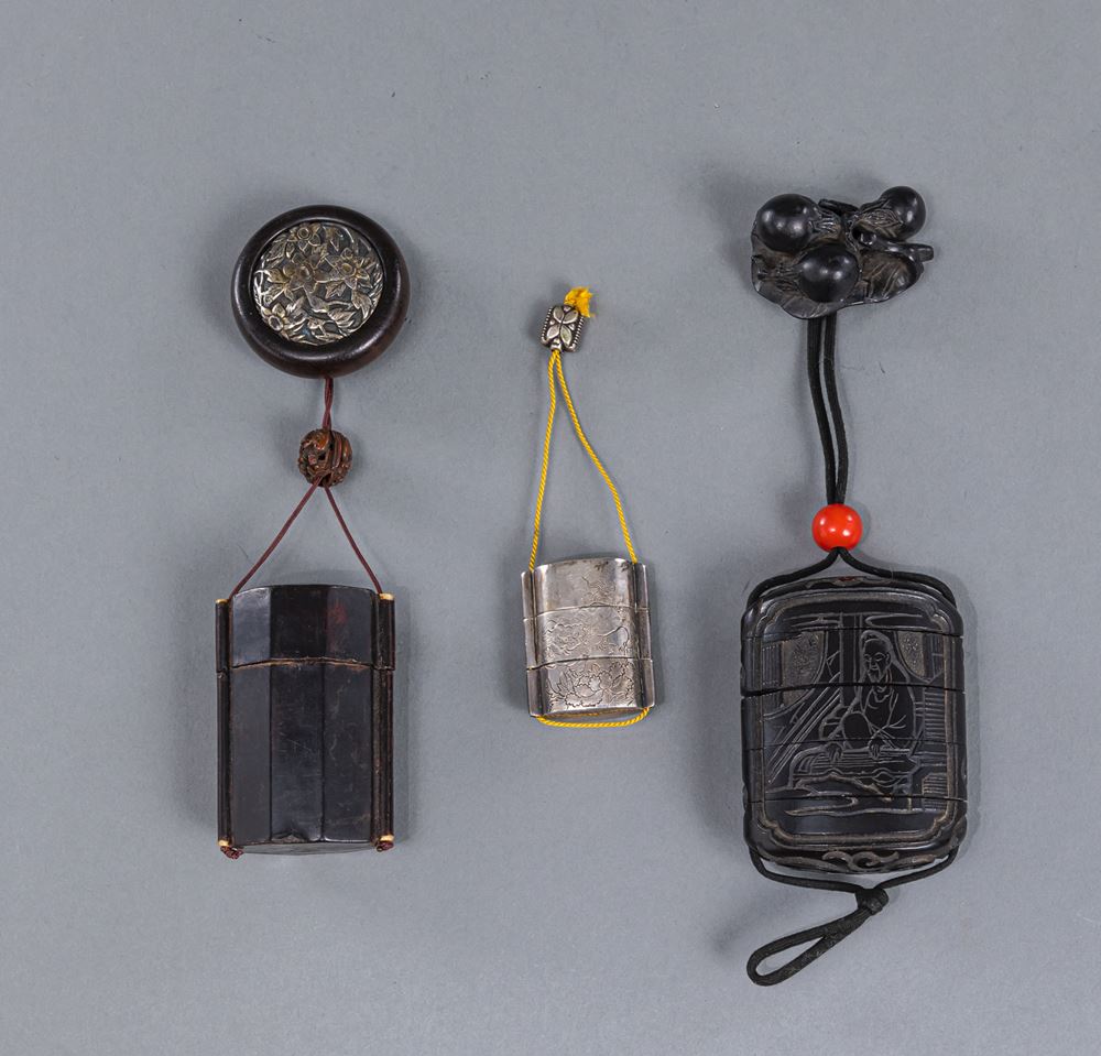 <b>TWO DARK LACQUERED WOOD INRO AND A SILVER INRO WITH ENGRAVED SHISHI DECORATION, ALL WITH NETSUKE AND OJIME</b>