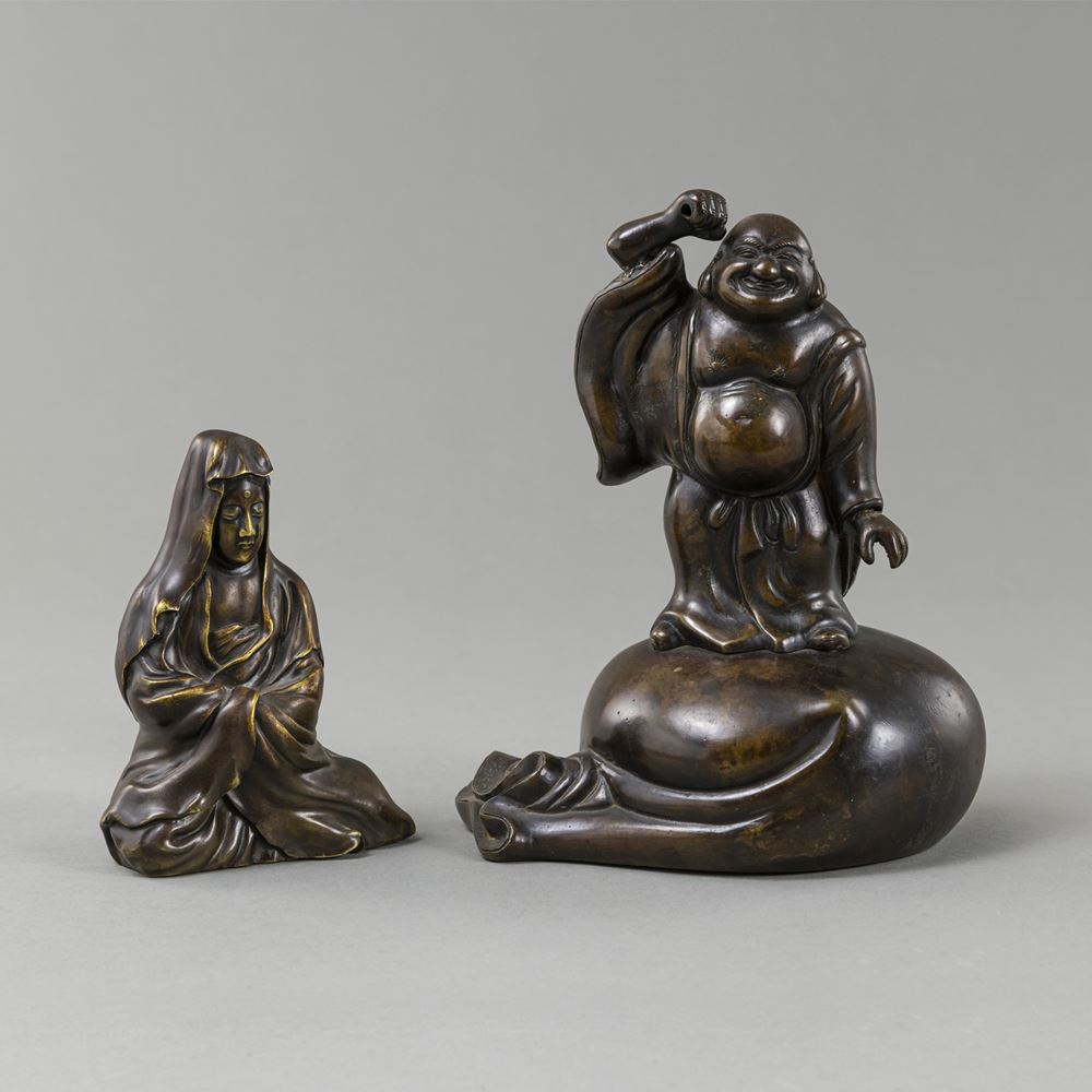 <b>TWO BRONZE FIGURES OF A SEATED KANNON AND HOTEI STANDING ON A LARGE SACK</b>