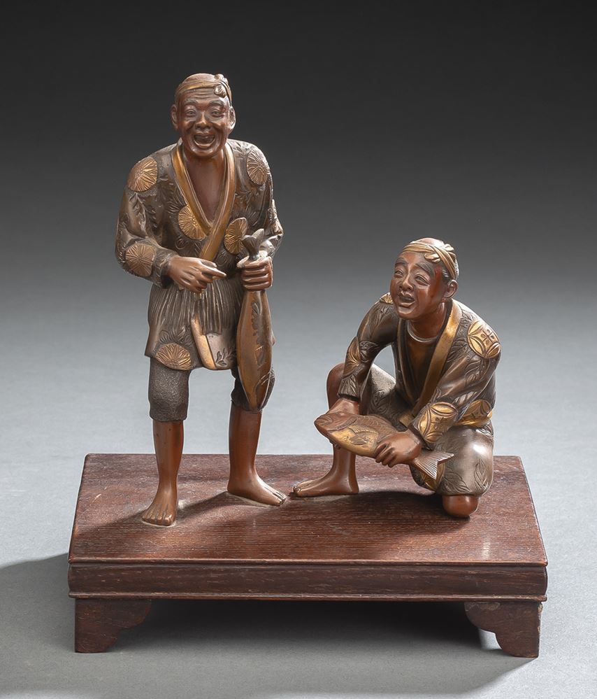 <b>A PART-GILT BRONZE GROUP OF TWO FISHERMEN WITH FISHES IN THE STYLE OF MIYAO EISUKE ON A WOOD STAND</b>