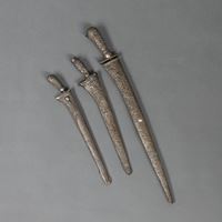 <b>THREE SHORT SWORDS WITH WHITE METAL SCABBARDS WITH FLORAL DECORATION</b>