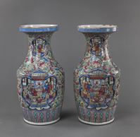 <b>A PAIR OF 'FAMILLE ROSE' VASES WITH THEATRICAL SCENES IN LARGE RESERVES ON A COLORFUL GROUND DECORATED WITH FLOWERS AND FRUITS</b>