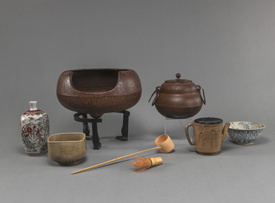 <b>A GROUP OF TEA CEREMONY UTENESILS WITH IRON HIBACHI AND CHAGAMA, CHAWAN AND BOWL, BAMBOO SPOON AND TEAPOT</b>
