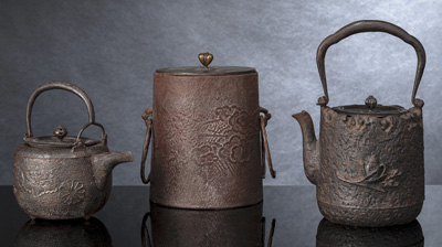 <b>AN IRON WATER KETTLE AND TWO IRON TETSUBIN WITH COVERS</b>