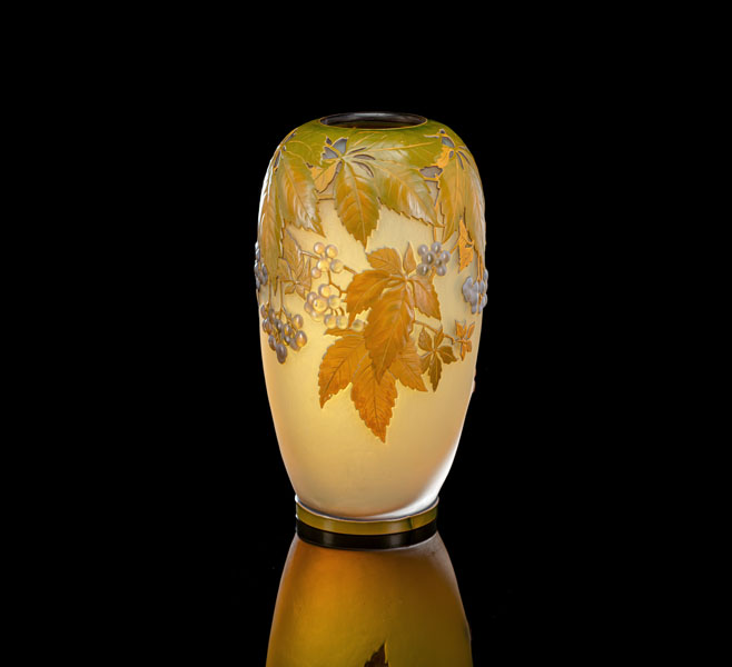 Of oval form, overlaid and acid-atched with yellow wine leaves and blue-violet soufflé grapes against a translucient yellow backround. Signed on body 