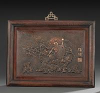 <b>A CAST  BRONZE PANEL DEPICTING HANDAKA SONJA SEATED ON A ROCK ACCOMPANIED BY A DRAGON</b>