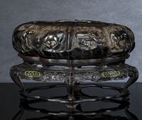 <b>A CARVED BROWN-GREEN SOAPSTONE BRUSH WASHER WITH THE 'EIGHT HORSES OF MU WANG' ON A FINELY CARVED WOOD STAND</b>