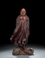 <b>A WELL CARVED LACQUERED AND PAINTED WOOD FIGURE OF BODHIDARMA ABOVE WAVES</b>