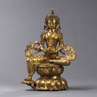 <b>A GILT-BRONZE FIGURE OF TARA ON A LOTUS PEDESTAL</b>