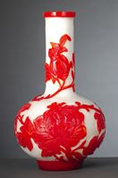 <b>A WHITE GLASS BOTTLE VASE WITH PEONIES IN RED OVERLAY</b>