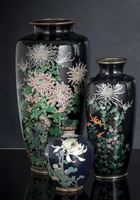 <b>A GROUP OF THREE CLOISONNÉ ENAMEL FLOWER VASES ON DARK BLUE GROUND</b>